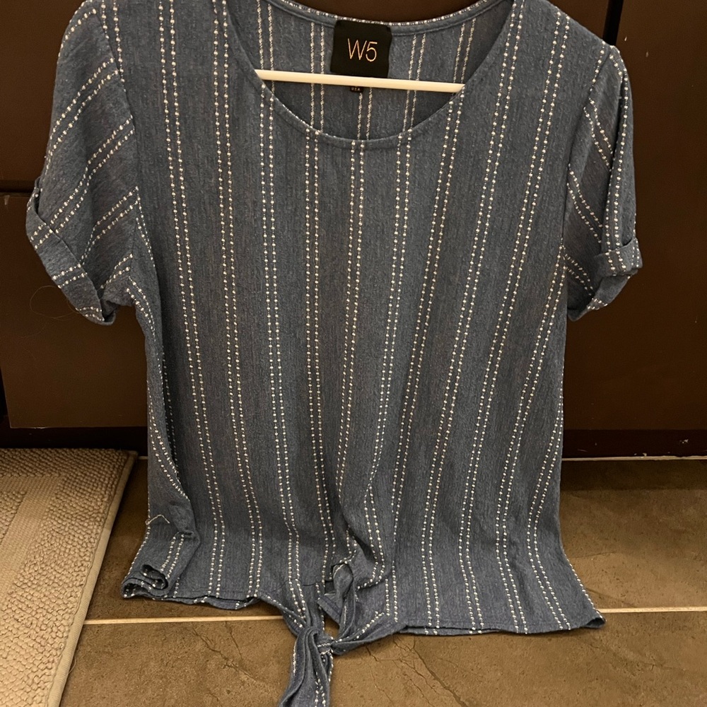 Blue and white blouse with knot at the bottom.